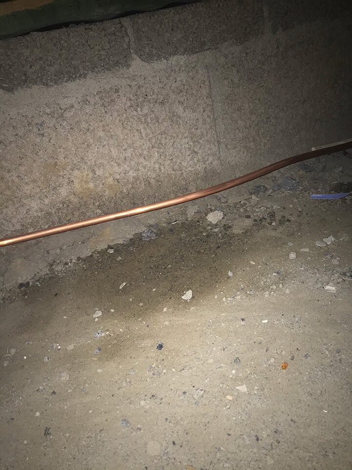 Oil pipe leak dripping onto concrete