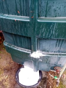 An oil tank that has failed and has had soap rubbed into the crack.